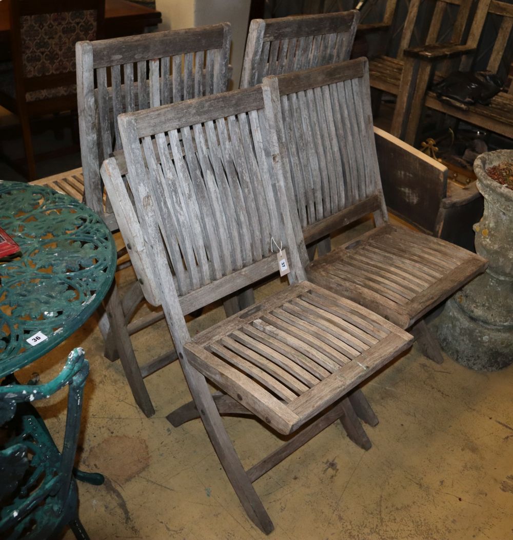 A set of six weathered teak folding garden chairs